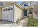 Charming townhome with a white garage door and green front door at 7822 South Kittredge Circle, Englewood, CO 80112
