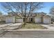 Street view of townhomes with attached garages and well-maintained lawns at 7822 South Kittredge Circle, Englewood, CO 80112
