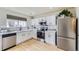Well-equipped kitchen with white cabinets, subway tile backsplash, and stainless steel appliances at 7822 South Kittredge Circle, Englewood, CO 80112
