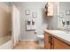 Cozy bathroom featuring a shower/tub combo, light colored walls, and warm, neutral colored tile at 5428 Zephyr Ct, Arvada, CO 80002