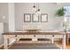 Beautiful dining room with modern light fixture, decorative art, and hardwood floors at 5428 Zephyr Ct, Arvada, CO 80002