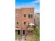 Multi-level brick home featuring private balconies with views of the community at 5428 Zephyr Ct, Arvada, CO 80002