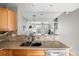 Open concept view into living area from kitchen with stainless steel dishwasher at 5428 Zephyr Ct, Arvada, CO 80002