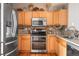 Spacious kitchen featuring stainless steel appliances, wooden cabinets, and hardwood floors at 5428 Zephyr Ct, Arvada, CO 80002