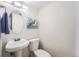 Clean and simple bathroom with pedestal sink and toilet at 12288 E Louisiana Dr, Aurora, CO 80012