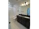 Bathroom with a double vanity, a tub with tiled walls, and modern fixtures at 2141 S Irvington St, Aurora, CO 80018