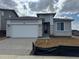 A charming single-story home featuring a two-car garage and stone accents on the facade at 2141 S Irvington St, Aurora, CO 80018