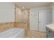 Well-lit bathroom with a tiled shower-tub featuring a glass enclosure and a decorative border at 2950 E 17Th Ave, Denver, CO 80206