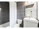 Stylish bathroom with grey vertical tiles, a floating vanity, a rectangular mirror, and a shower with a curtain at 2950 E 17Th Ave, Denver, CO 80206