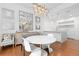 Bright dining area with modern chandelier, table, and chairs next to the island kitchen with wood floors at 2950 E 17Th Ave, Denver, CO 80206