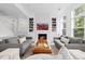 Bright living room with a fireplace, stylish decor, and hardwood floors providing a modern look at 2950 E 17Th Ave, Denver, CO 80206