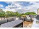 Spacious outdoor patio with comfortable wicker seating, a dining table, a grill, and scenic views at 2950 E 17Th Ave, Denver, CO 80206