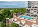 Scenic rooftop pool overlooking a lush green landscape, complete with lounge chairs and city views at 2950 E 17Th Ave, Denver, CO 80206