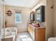 Bright bathroom features a soaking tub, double vanity with vessel sinks, and modern fixtures at 3893 Ute Mountain Trl, Castle Rock, CO 80109