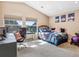 Bright bedroom with two windows, a desk, a comfortable bed, and carpet flooring at 3893 Ute Mountain Trl, Castle Rock, CO 80109