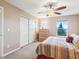 Bright bedroom featuring a comfortable bed, closet, window, and wooden dresser at 3893 Ute Mountain Trl, Castle Rock, CO 80109