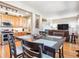 The dining area has a large dark wood table with hardwood floors and a view of the living room at 3893 Ute Mountain Trl, Castle Rock, CO 80109