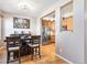The dining area features hardwood floors, a large dark wood table, and a picturesque wall art at 3893 Ute Mountain Trl, Castle Rock, CO 80109