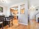 The dining area has hardwood floors, a large dark wood table and view into the kitchen at 3893 Ute Mountain Trl, Castle Rock, CO 80109