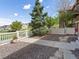 Charming front yard features a white picket fence, a mature evergreen tree, and a landscaped gravel area at 3893 Ute Mountain Trl, Castle Rock, CO 80109