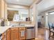 Well-equipped kitchen with stainless steel appliances, hardwood floors, and staircase view at 3893 Ute Mountain Trl, Castle Rock, CO 80109