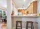 The kitchen has light wood cabinets, stainless steel appliances, and an adjacent dining area at 3893 Ute Mountain Trl, Castle Rock, CO 80109