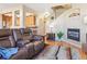 The living room includes a leather sofa, fireplace, and view into the kitchen at 3893 Ute Mountain Trl, Castle Rock, CO 80109