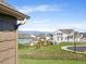View of a well-maintained neighborhood with green spaces, sidewalks, and mountain views against a blue sky at 3893 Ute Mountain Trl, Castle Rock, CO 80109
