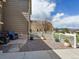 Cozy patio area with stone accents, chairs, and a decorative fence showcasing flower pots at 3893 Ute Mountain Trl, Castle Rock, CO 80109