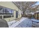 Backyard, showing patio area, fencing, house wall with door and window at 1700 W Stoll Pl, Denver, CO 80221