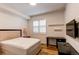 Bedroom with a bed, desk, TV, window, and shelves at 2200 S University Blvd # 212, Denver, CO 80210