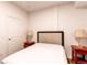 Cozy bedroom with a queen bed, two side tables, and a door at 2200 S University Blvd # 212, Denver, CO 80210