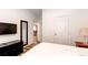 Bedroom with a dresser, TV, mirror, and door leading to another room at 2200 S University Blvd # 212, Denver, CO 80210