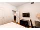 Bright bedroom with television and adjacent door to other living spaces at 2200 S University Blvd # 212, Denver, CO 80210