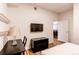 This room features a desk, TV, wood floors, and leads into another room at 2200 S University Blvd # 212, Denver, CO 80210