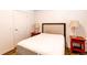 Bedroom with a bed, two side tables with lamps, and a door at 2200 S University Blvd # 212, Denver, CO 80210