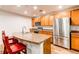 Bright eat-in kitchen features stainless steel appliances, granite counters, and wood cabinets at 2200 S University Blvd # 212, Denver, CO 80210