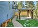 Backyard featuring a gazebo, bench, and a pathway, surrounded by trees and green grass at 27732 Squaw Pass Rd, Evergreen, CO 80439