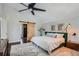 A modern bedroom featuring a sliding barn door closet, a plush rug, and plenty of natural light at 27732 Squaw Pass Rd, Evergreen, CO 80439