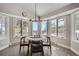 Cozy dining room with mountain views, hardwood floors, and a modern chandelier at 27732 Squaw Pass Rd, Evergreen, CO 80439