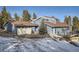 Charming two-story home with a brown roof, blue siding and an attached garage at 27732 Squaw Pass Rd, Evergreen, CO 80439