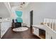 A cozy hallway with a reading nook, a comfortable chair, and lots of natural light at 27732 Squaw Pass Rd, Evergreen, CO 80439