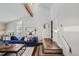 Bright living room featuring vaulted ceiling, hardwood floors, and a comfortable blue sofa at 27732 Squaw Pass Rd, Evergreen, CO 80439