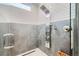 Sleek shower featuring modern fixtures, a rainfall showerhead, and elegant tile work at 27732 Squaw Pass Rd, Evergreen, CO 80439