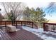 Large wooden deck with snow coverage offers expansive views of the surrounding landscape at 25871 E 5Th Pl, Aurora, CO 80018