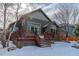 Home exterior showcasing a large deck, gray siding, and snowy backyard at 25871 E 5Th Pl, Aurora, CO 80018