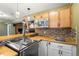 Entertaining bar area with wooden countertop, sink, microwave, and beer tap for added convenience and fun at 25871 E 5Th Pl, Aurora, CO 80018