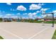 Outdoor basketball court under a blue sky with basketball hoop and nearby park at 25871 E 5Th Pl, Aurora, CO 80018