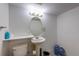 Simple half bathroom with pedestal sink, toilet, and overhead lighting at 25871 E 5Th Pl, Aurora, CO 80018