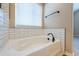 Bright bathroom features a soaking tub and tiled walls at 25871 E 5Th Pl, Aurora, CO 80018